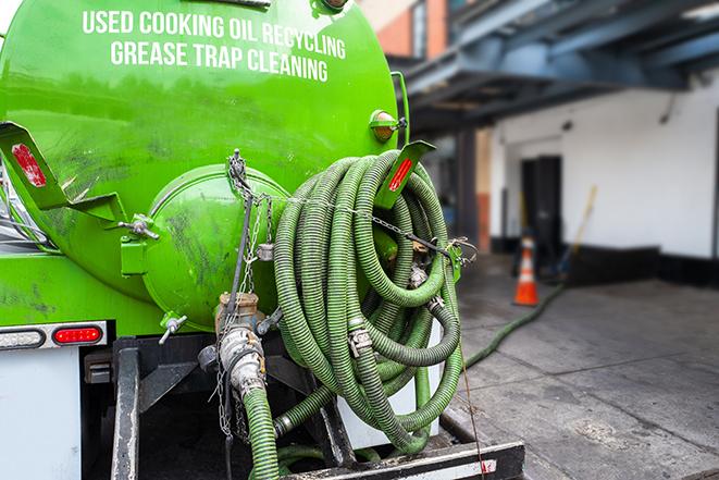 a grease trap pumping truck at a restaurant in Burlington MI